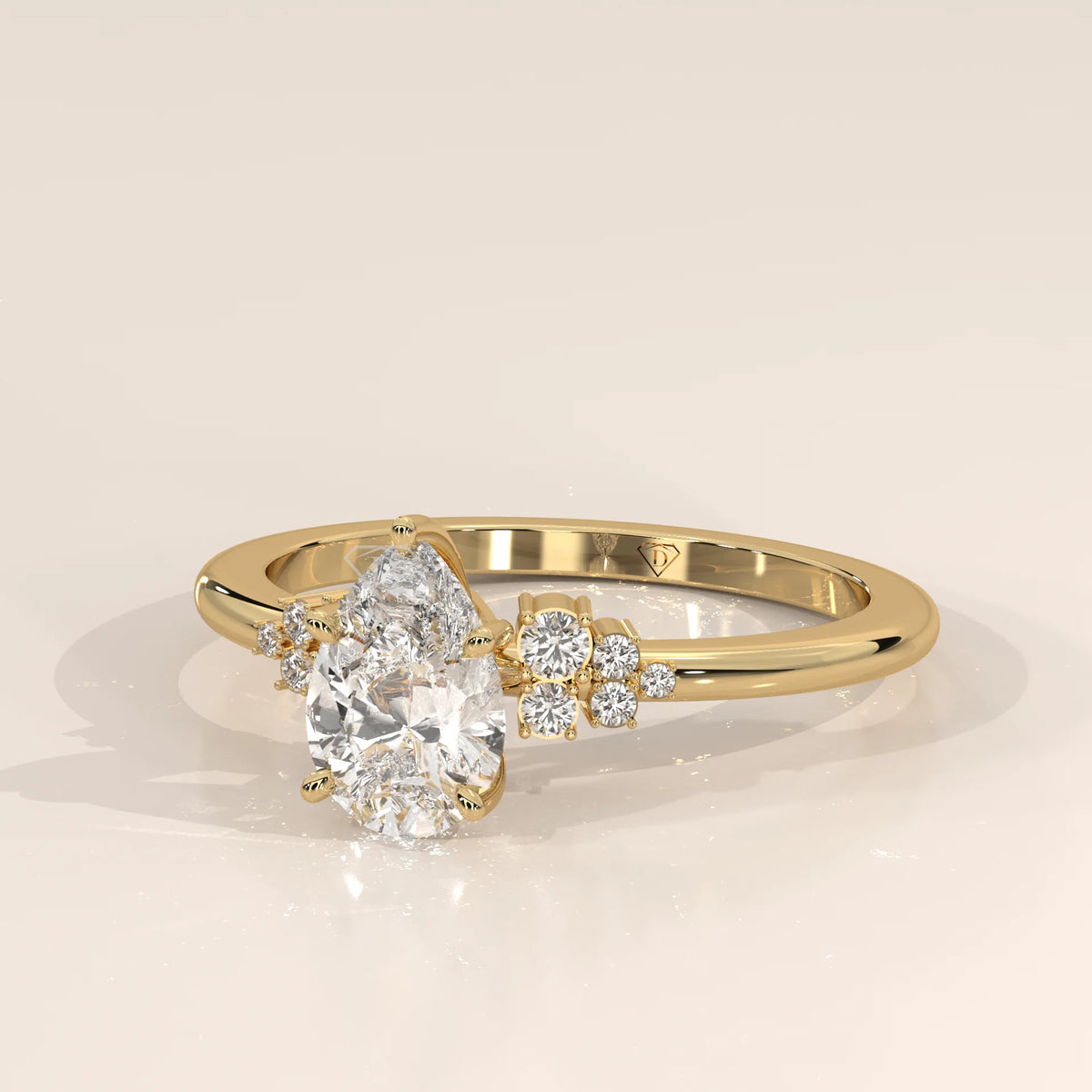 Gold ring with a pear-shaped diamond and smaller diamonds.