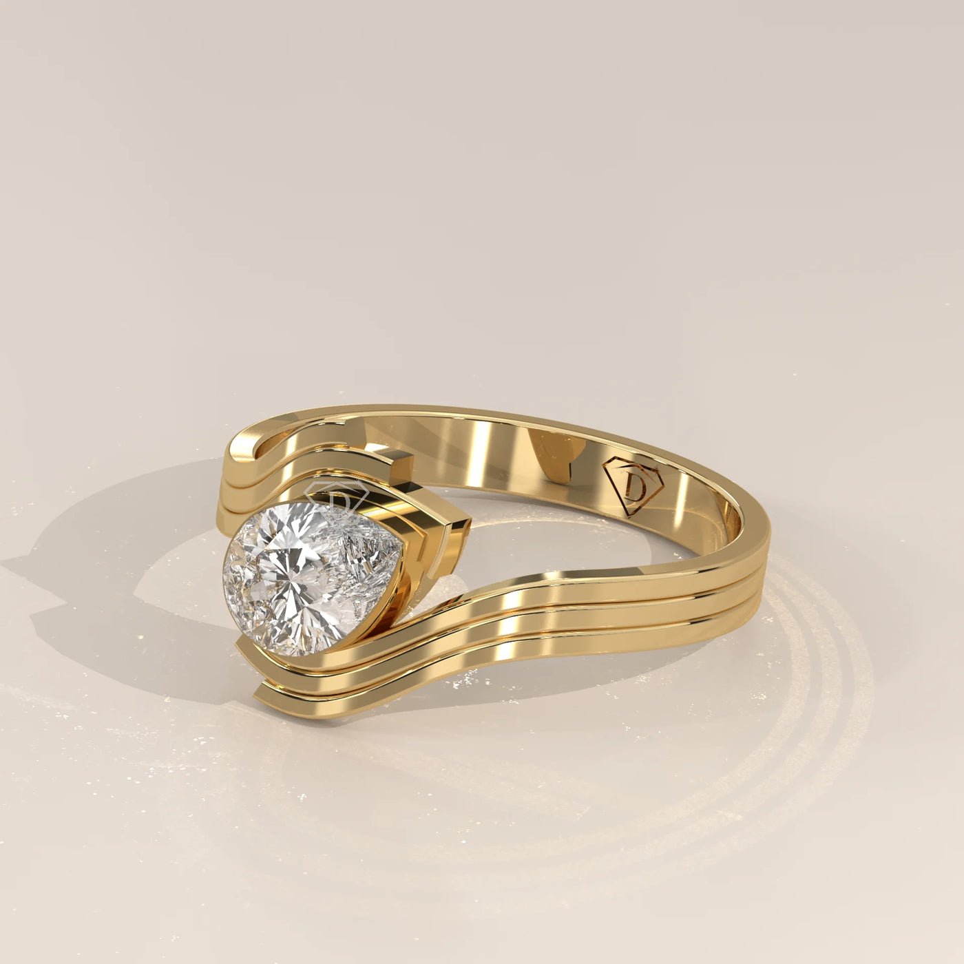 A modern yellow gold ring with a pear-shaped diamond.