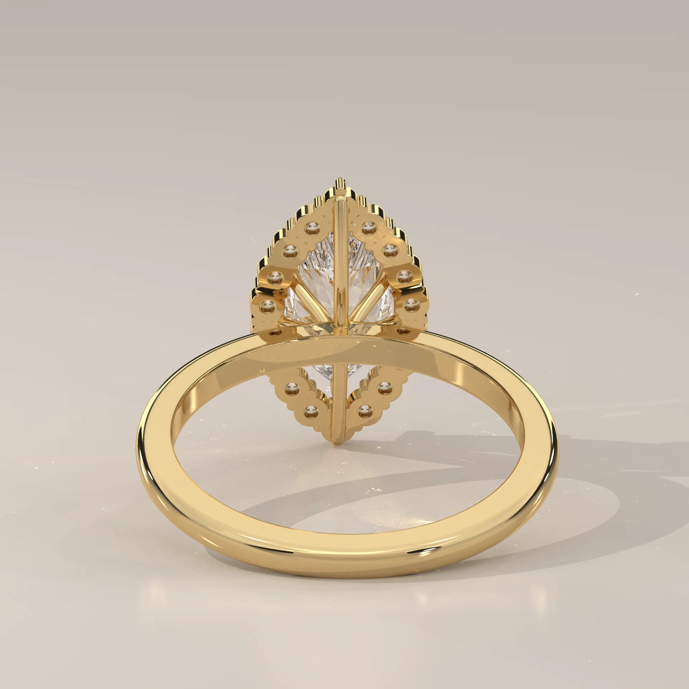 Gold ring with a pear-shaped diamond and halo.