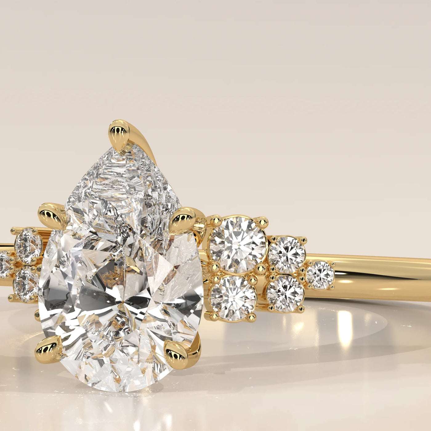 A delicate 14k gold ring featuring a pear-cut diamond and accent stones.