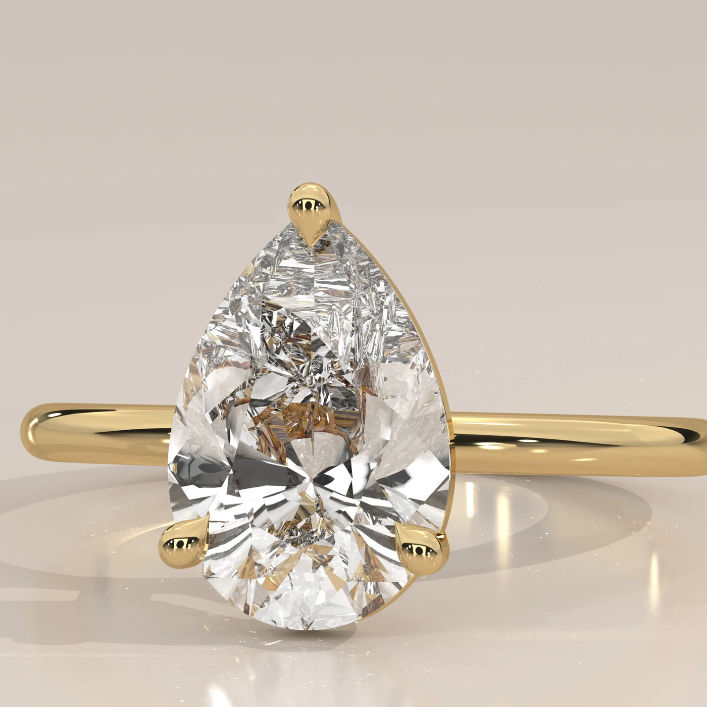 A dazzling pear-shaped diamond engagement ring set in 14k gold.