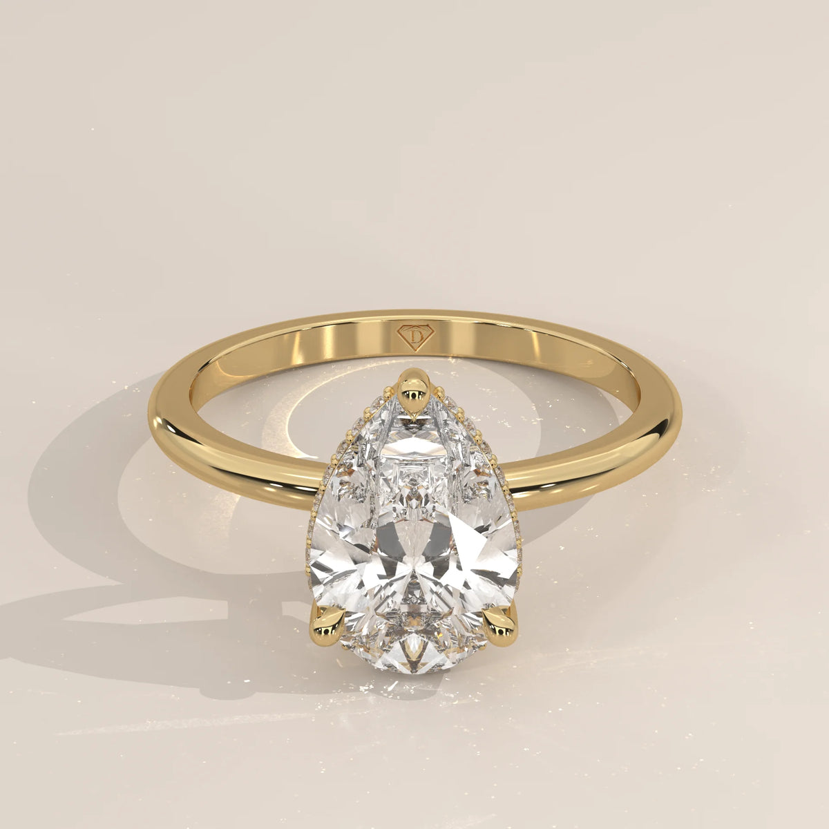 A dazzling pear-shaped diamond engagement ring set in 14k gold.