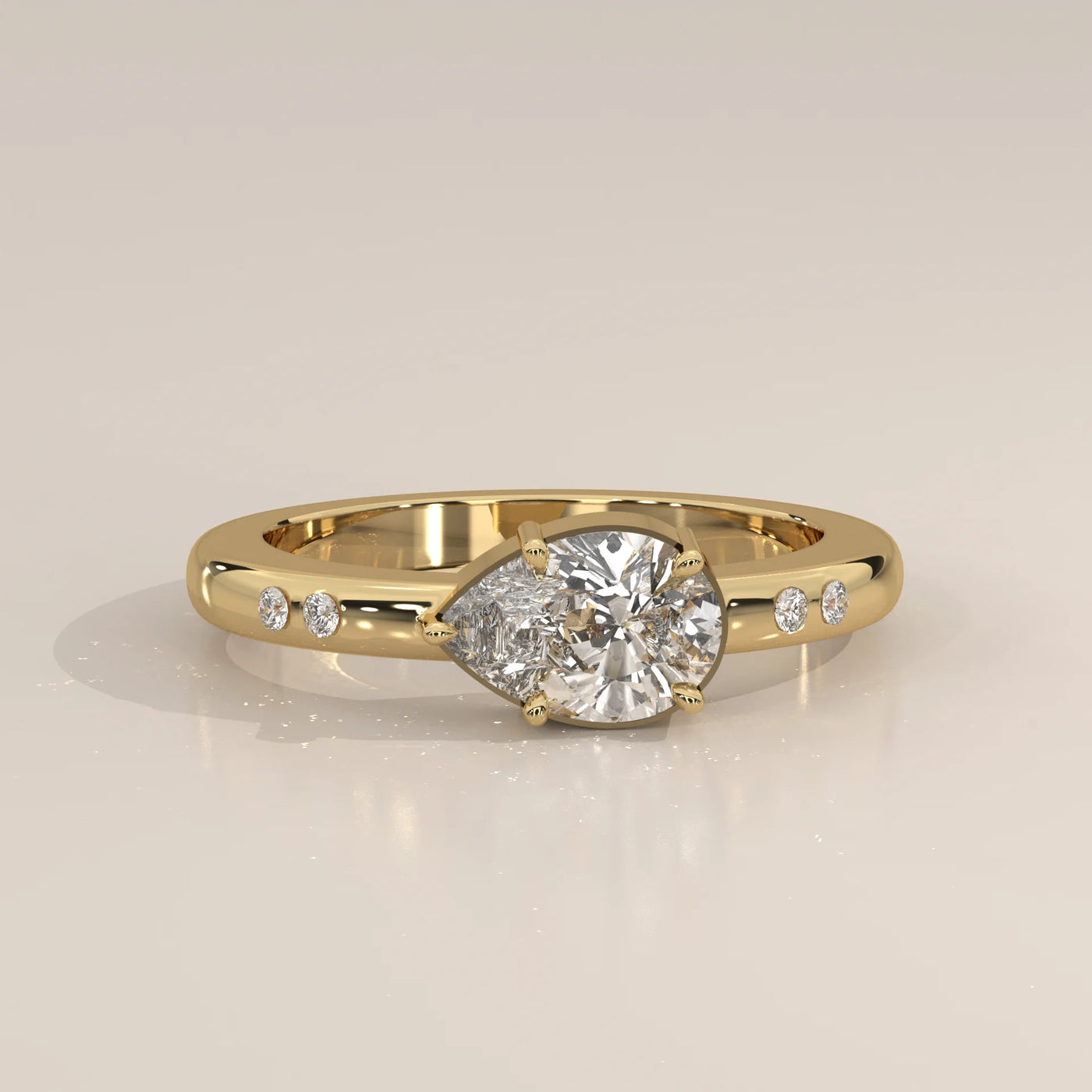 A 14k gold bypass ring with a pear-cut diamond.