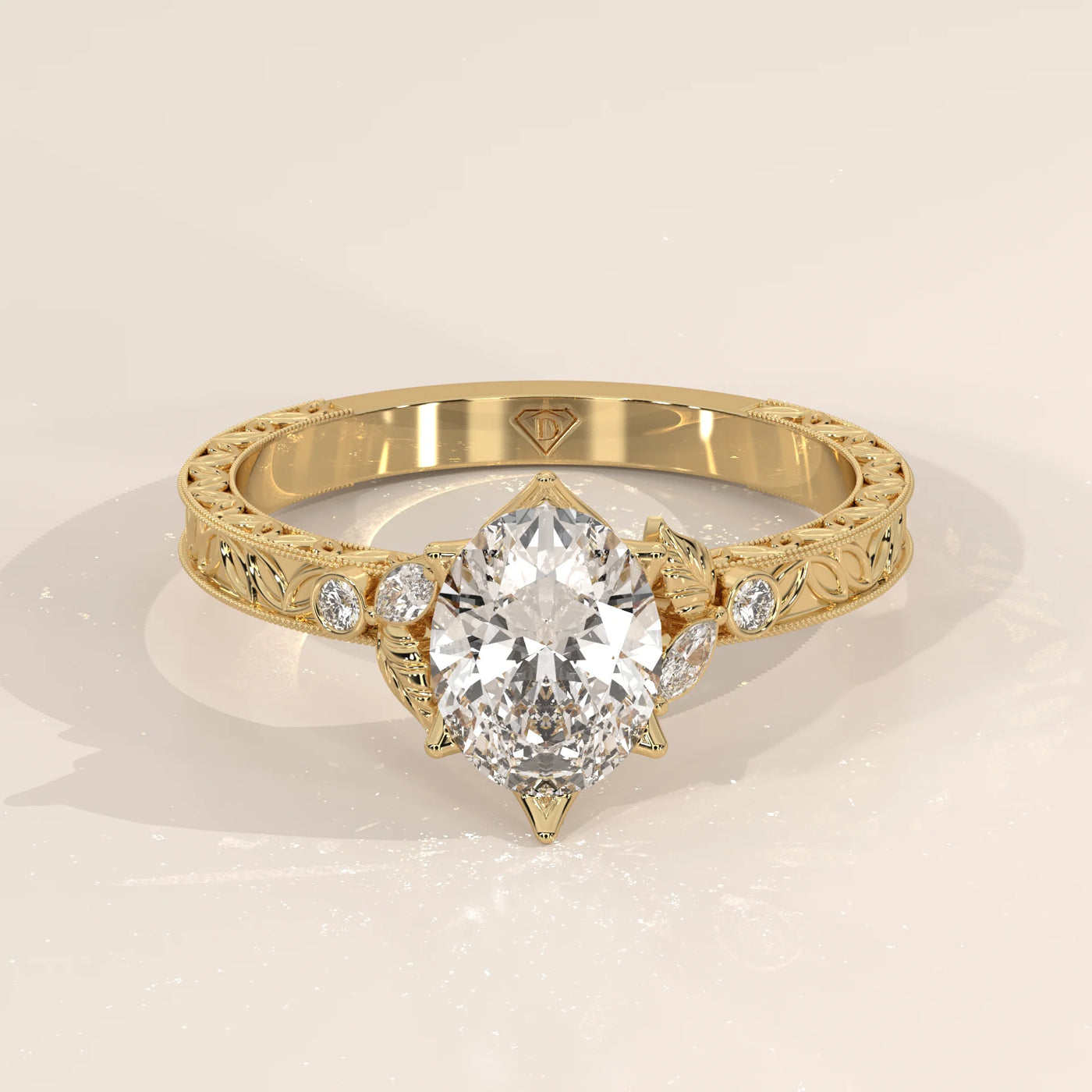 Elegant 14k gold ring with a pear-shaped diamond and intricate band design.