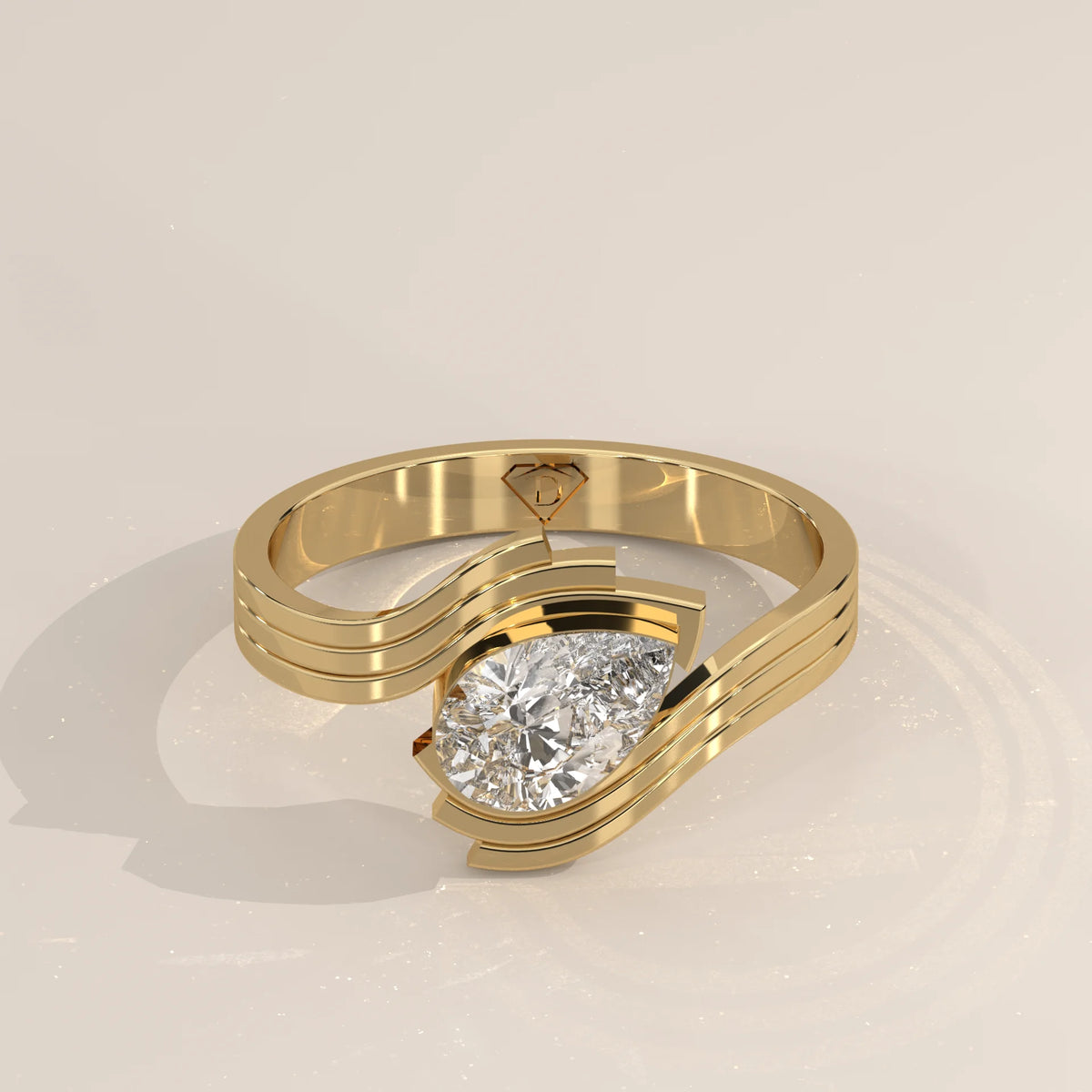 A 14k gold bypass ring with a pear-cut diamond.