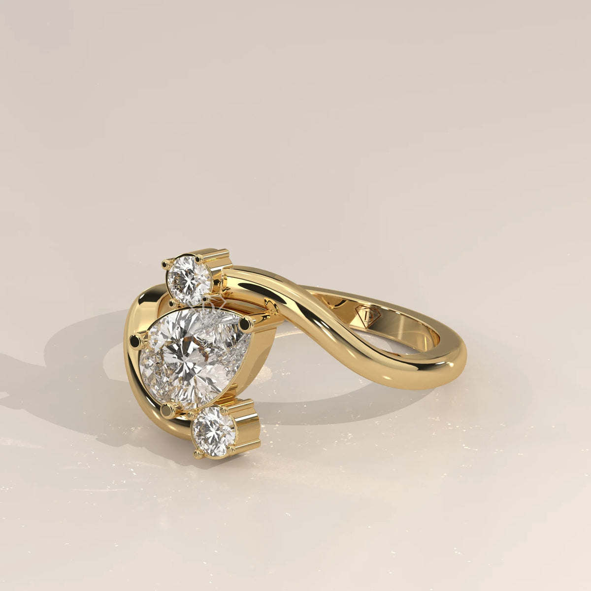 Gold ring with a pear-shaped diamond and two round diamonds.