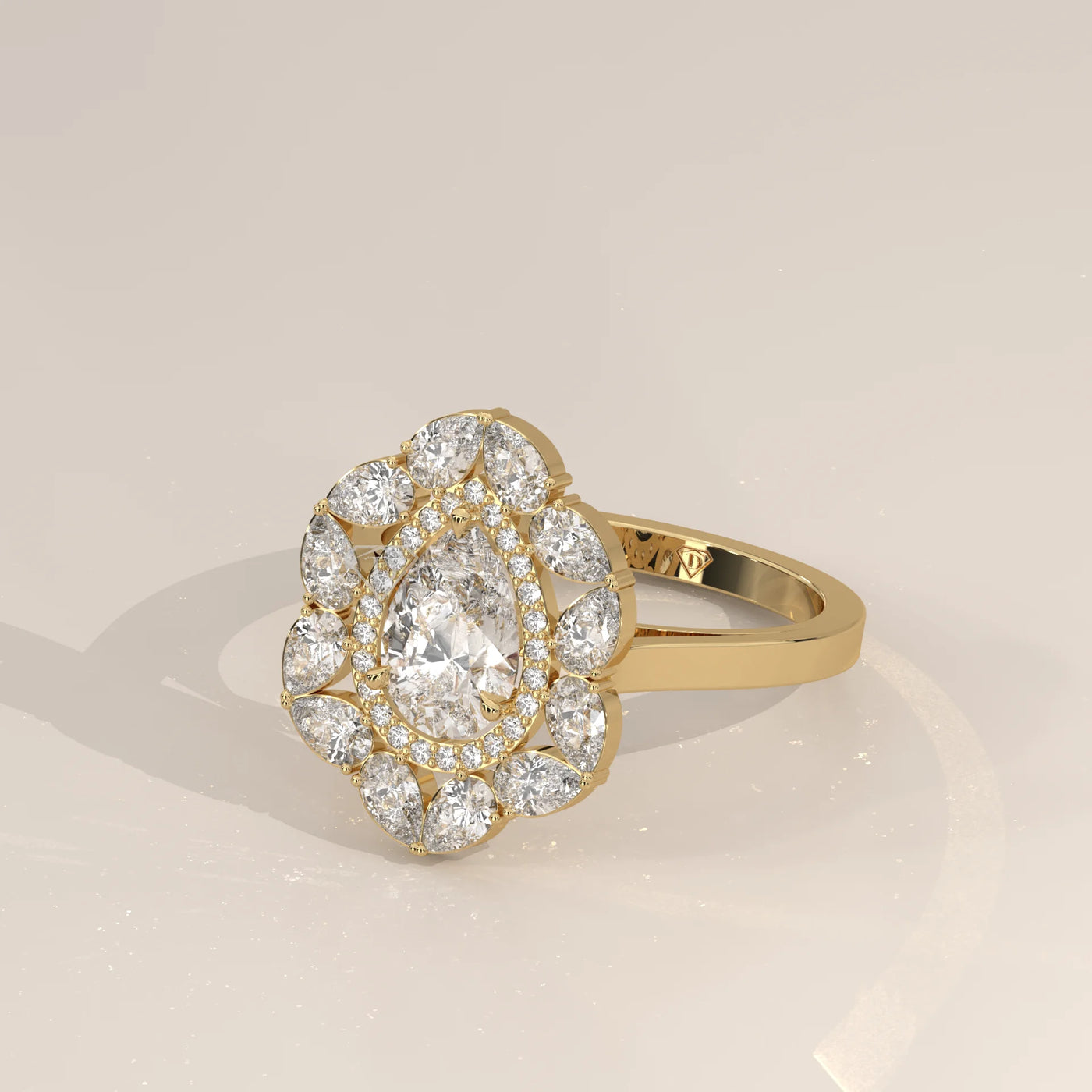 Gold ring with a pear-shaped diamond and two round diamonds.