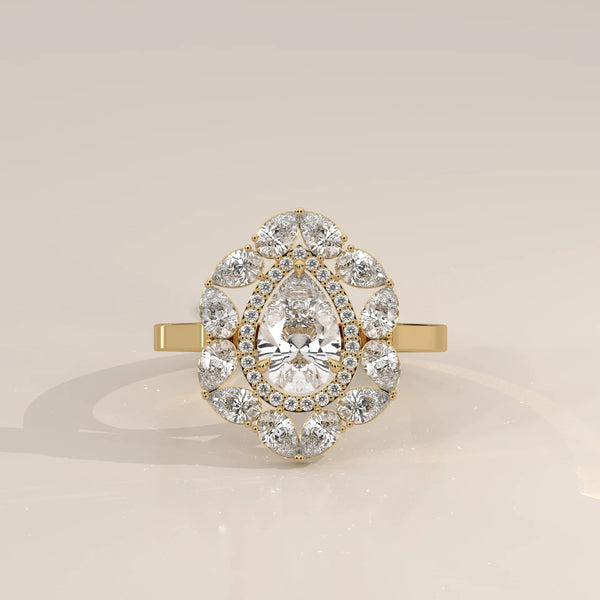 Elegant 14k yellow gold ring featuring a pear-cut diamond surrounded by a halo of smaller diamonds.