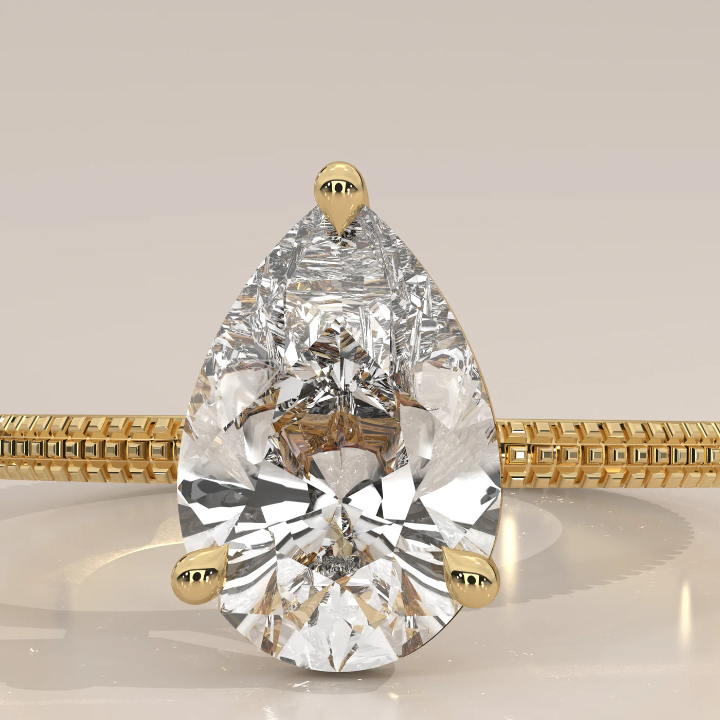 A pear-shaped diamond engagement ring in yellow gold.