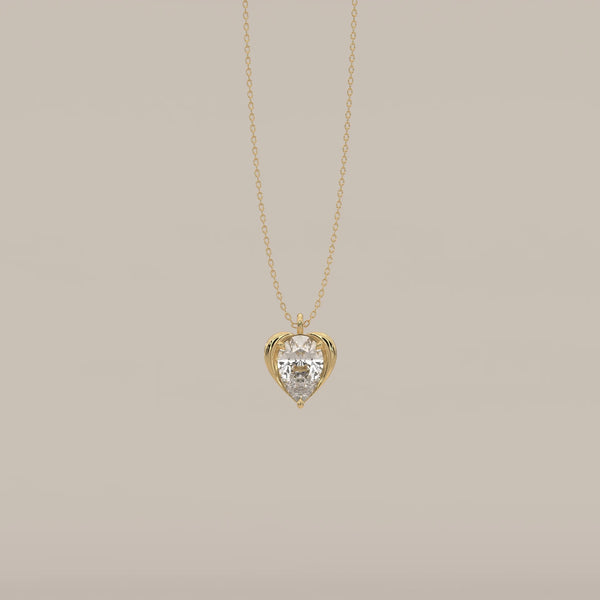 Pear Lab Grown Diamond Pendant Cradled in a Sculpted Heart Frame in yellow gold, shown from the front.