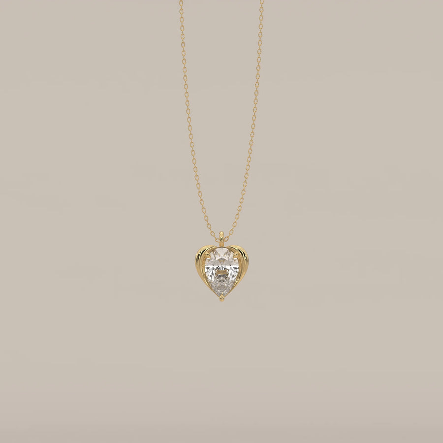 Pear Lab Grown Diamond Pendant Cradled in a Sculpted Heart Frame in yellow gold, shown from the front.