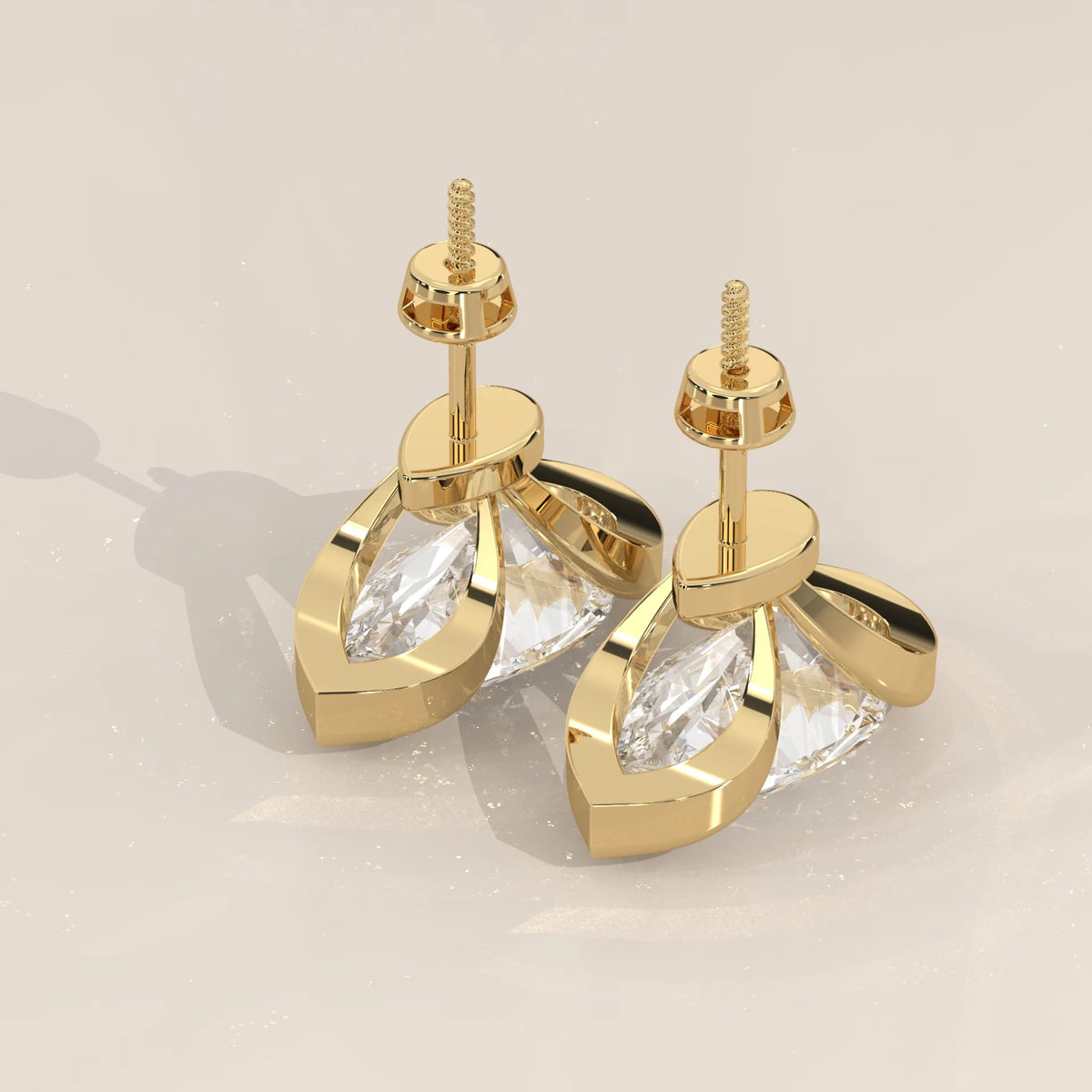 Pear Lab Grown Diamond Studs in a Curving Open Bezel in yellow gold, product photograph on a plain background.