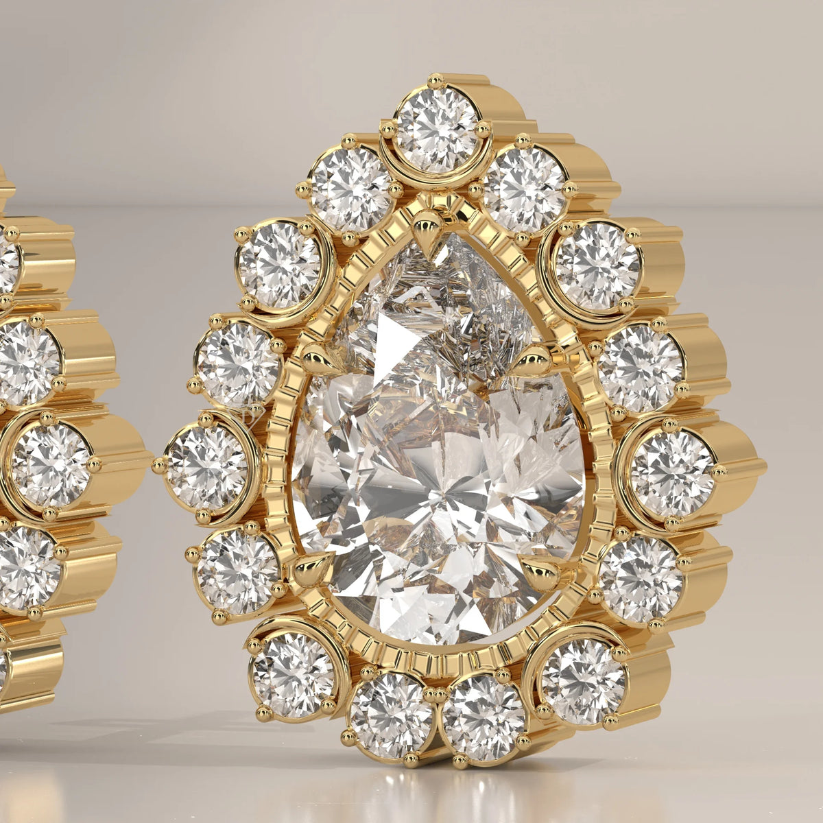 Pear Lab Grown Diamond Studs in a Raised Cup Halo with Milgrain in yellow gold, shown at an angle.
