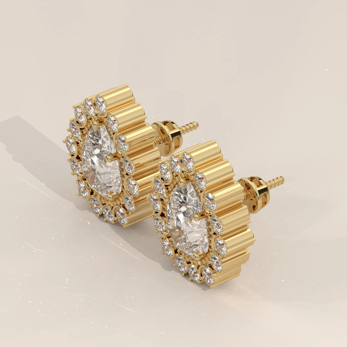Pear Lab Grown Diamond Studs in a Raised Cup Halo with Milgrain in yellow gold, shown from the side.