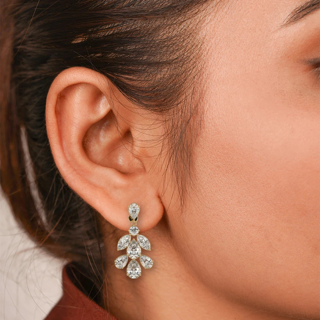 Pear and Marquise Lab Grown Diamond Leaf Cluster Drop Earrings in yellow gold, worn on the model.