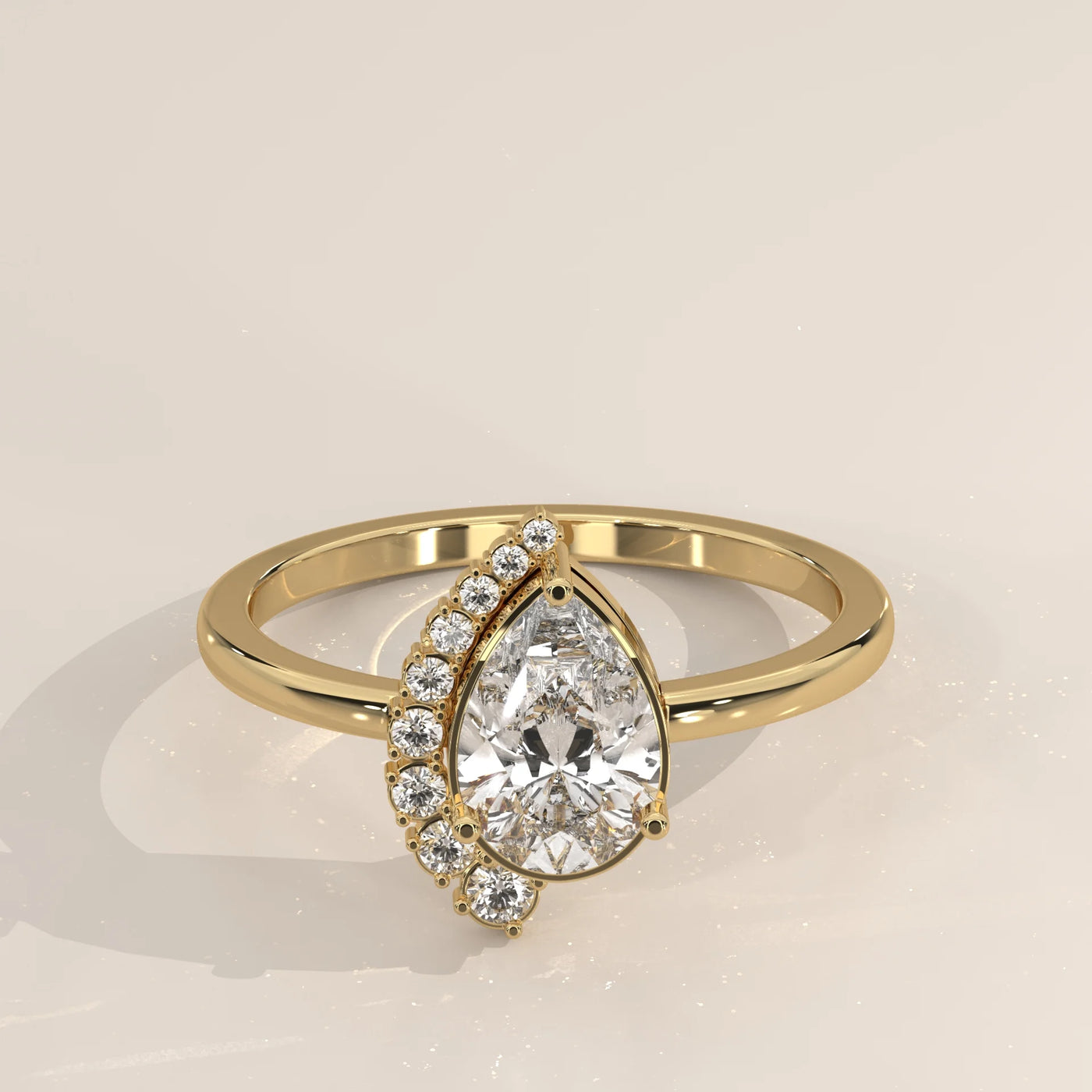 A pear-shaped diamond ring with accent diamonds in gold.