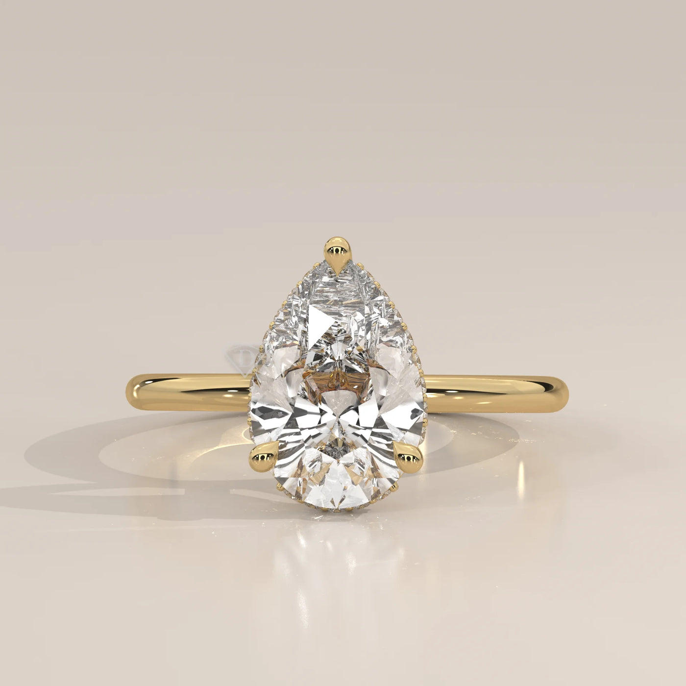 A classic 14k gold ring featuring a pear-shaped diamond.
