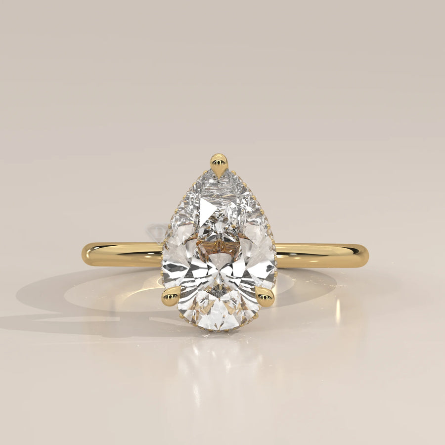 A classic 14k gold ring featuring a pear-shaped diamond.