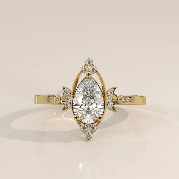 Elaborate yellow gold ring with a pear-shaped diamond center, accented with smaller stones.