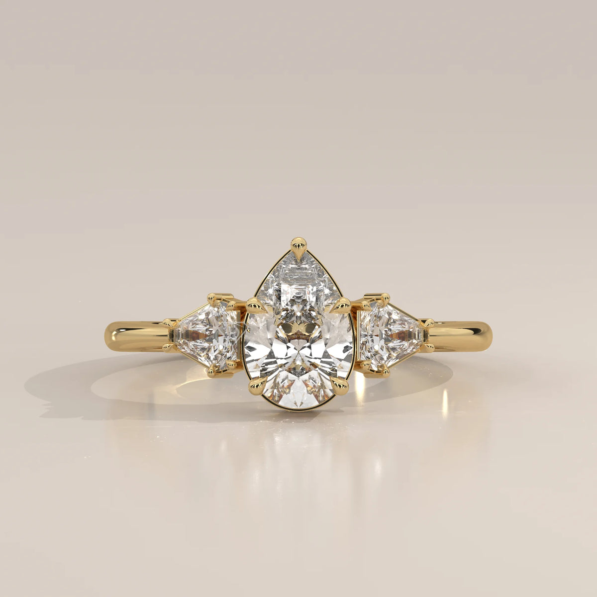 Pear Lab Grown Diamond Three Stone Ring with Shield Cut Sides in yellow gold, photographed head-on.