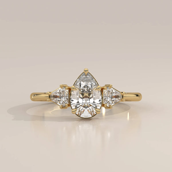 Pear Lab Grown Diamond Three Stone Ring with Shield Cut Sides in yellow gold, photographed head-on.