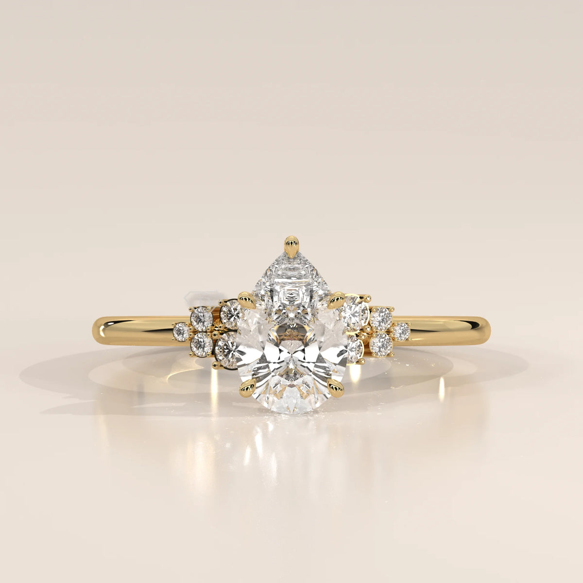 Yellow gold ring with a pear-cut diamond and smaller accent stones.