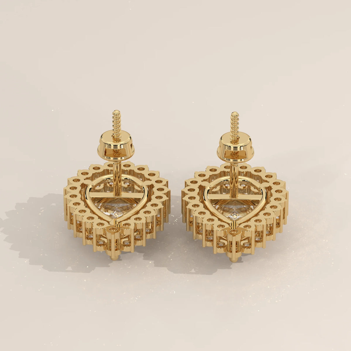 Pear Shape Halo Lab Grown Diamond Stud Earrings with Screw Backs in yellow gold, studio photograph on a plain background.