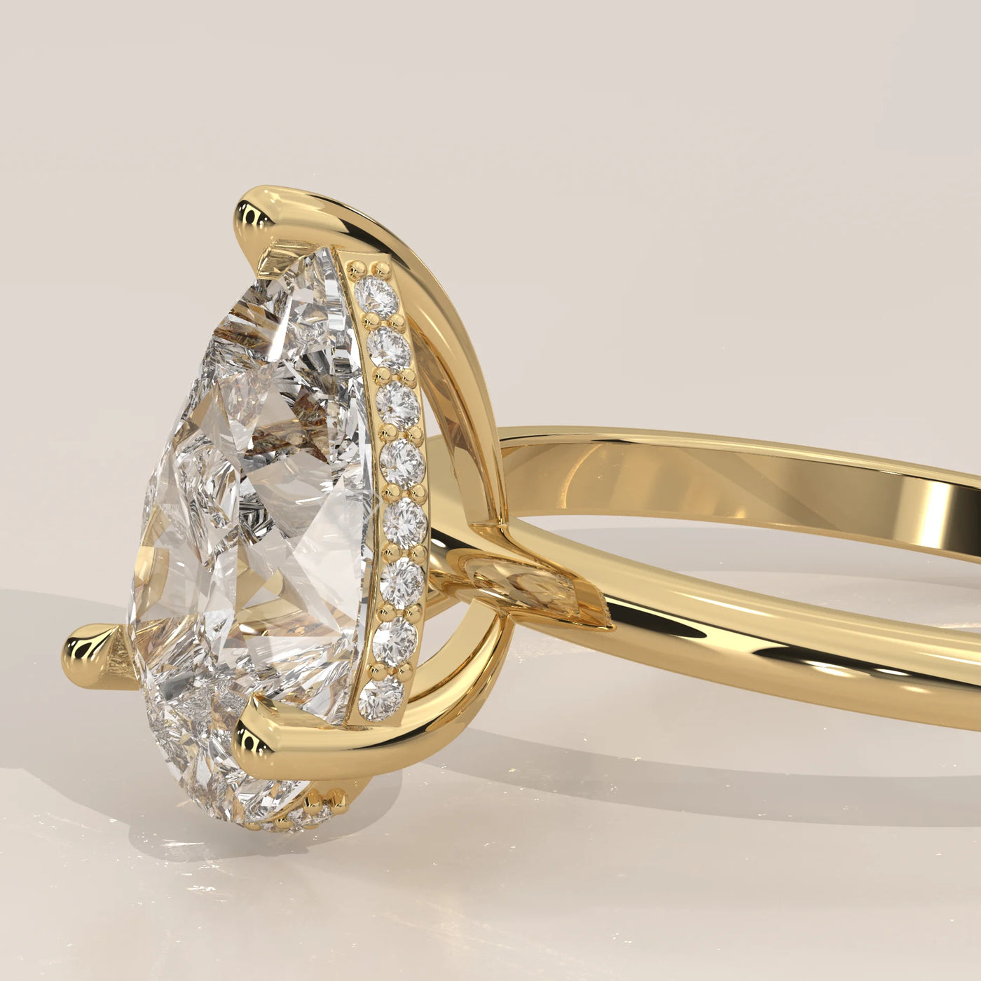 A 14k gold ring with a pear-shaped diamond and small accent diamonds.