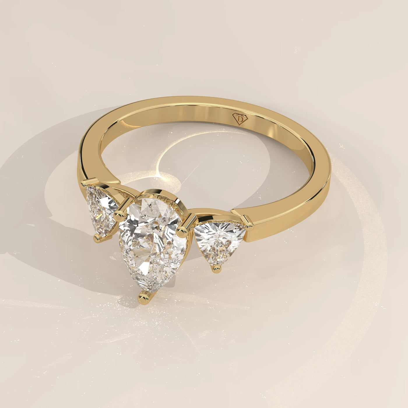 Angle View: Pear Diamond Engagement Ring with Three-Stone Setting in Yellow Gold – Lab Grown – Driona Jewels