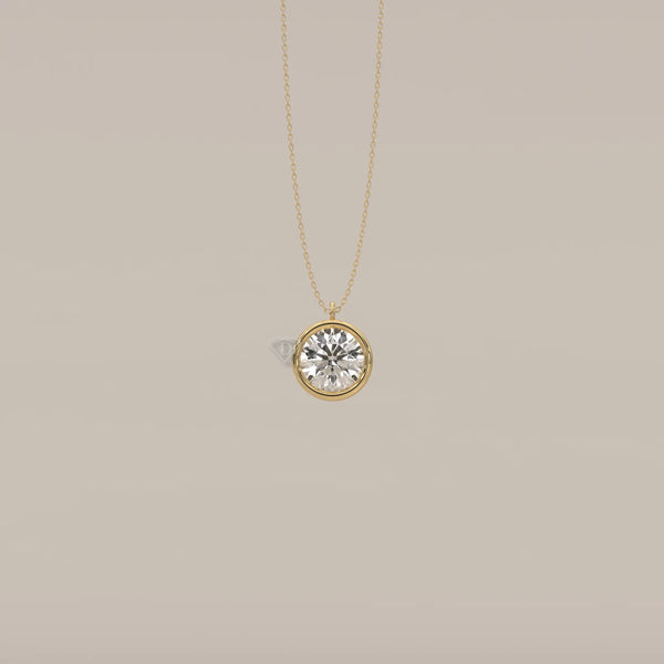 Gold pendant necklace with a large round diamond in a bezel setting.