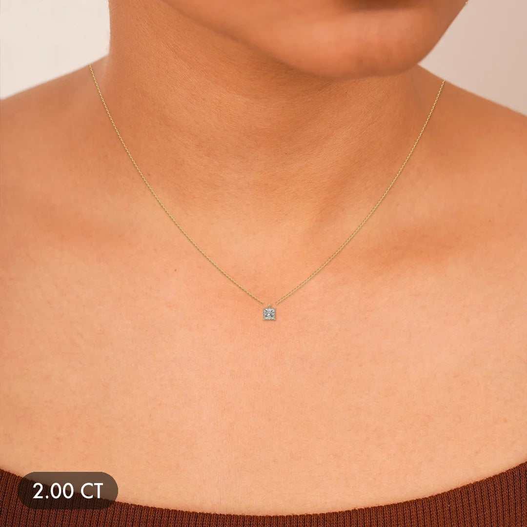 A delicate 14k gold necklace with a single diamond pendant.