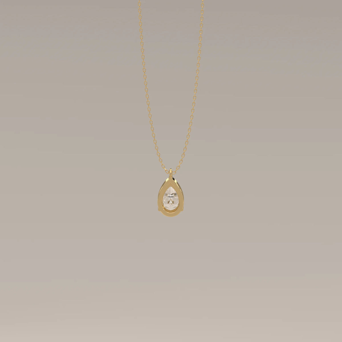 A delicate gold chain holding a teardrop pendant with a single pear-shaped diamond.