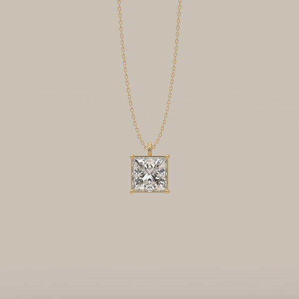 A classic 14k yellow gold pendant with a princess-cut diamond.