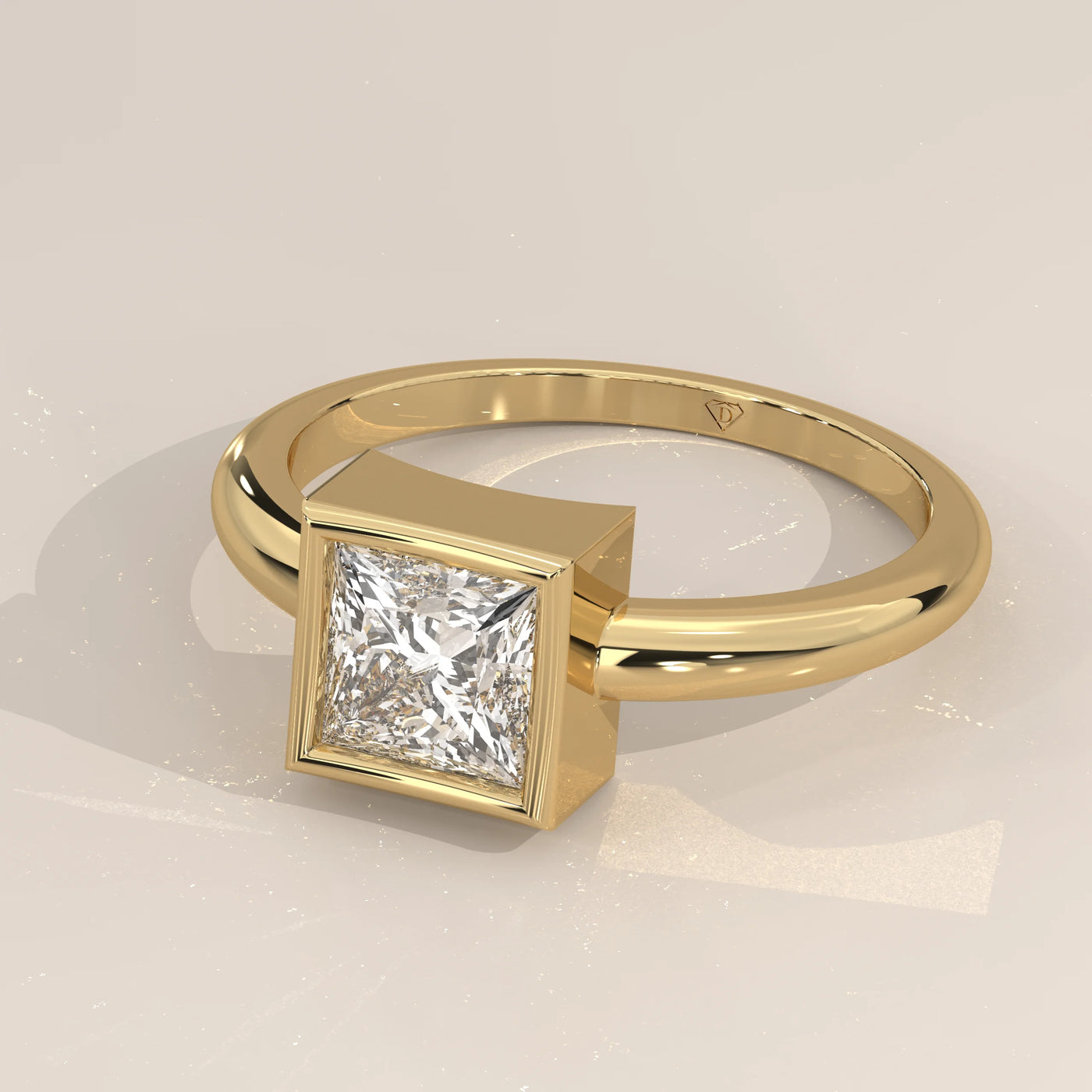 A solitaire ring with a princess-cut diamond in a yellow gold band.