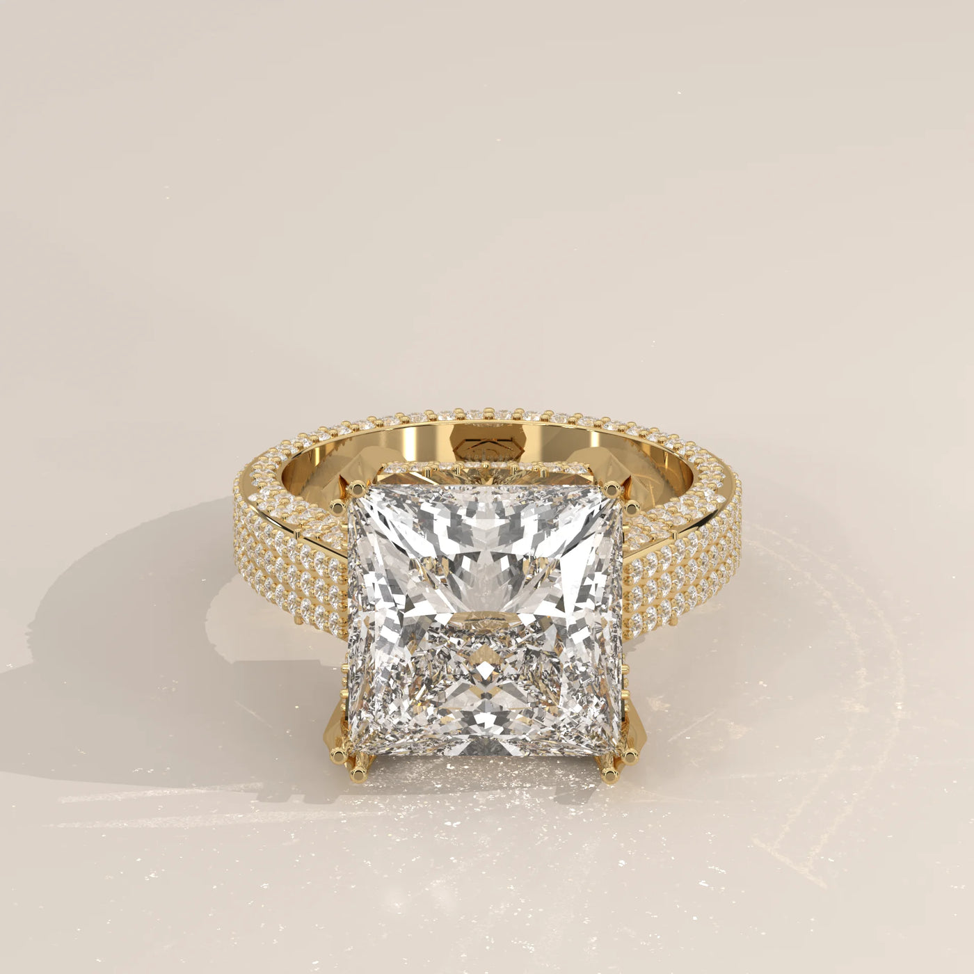 A stunning 14k yellow gold engagement ring with a large princess-cut diamond and pav

e-set side stones.