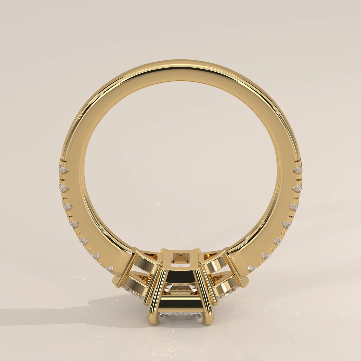 Emerald Cut Lab Grown Diamond Three Stone Ring with Trillion Sides in yellow gold, shown from the side.