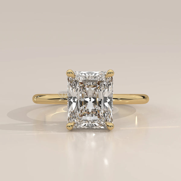 Classic 14k yellow gold ring with a radiant cut diamond.