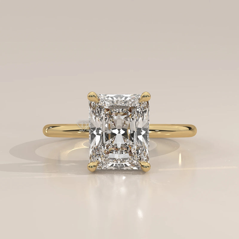 Classic 14k yellow gold ring with a radiant cut diamond.