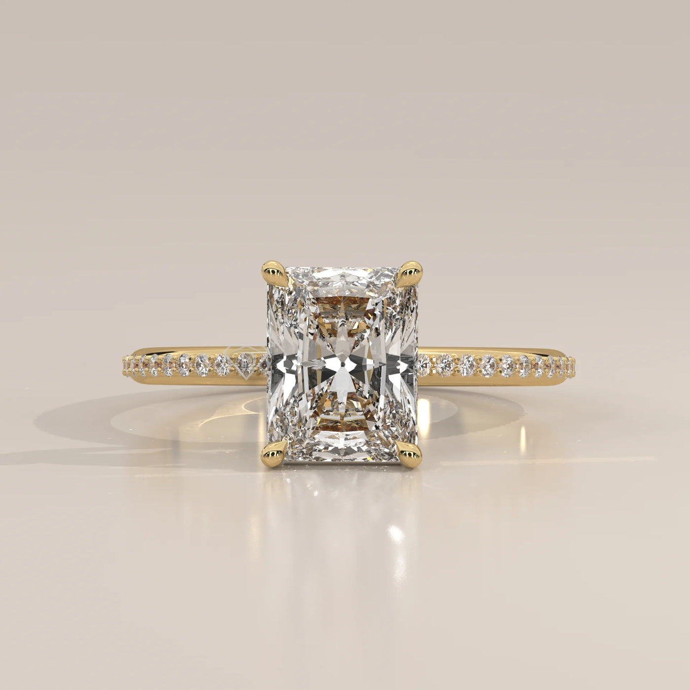 A classic 14k yellow gold ring with a radiant cut diamond and pave band.