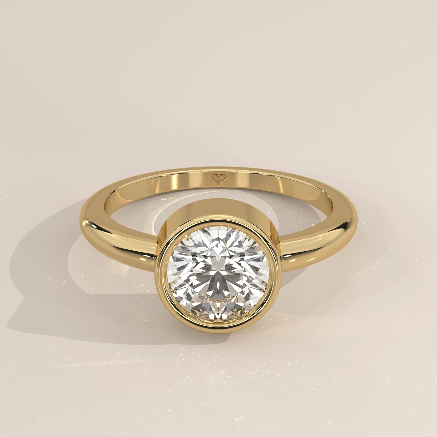 Gold ring with a round diamond set in a bezel setting, shown from the front.