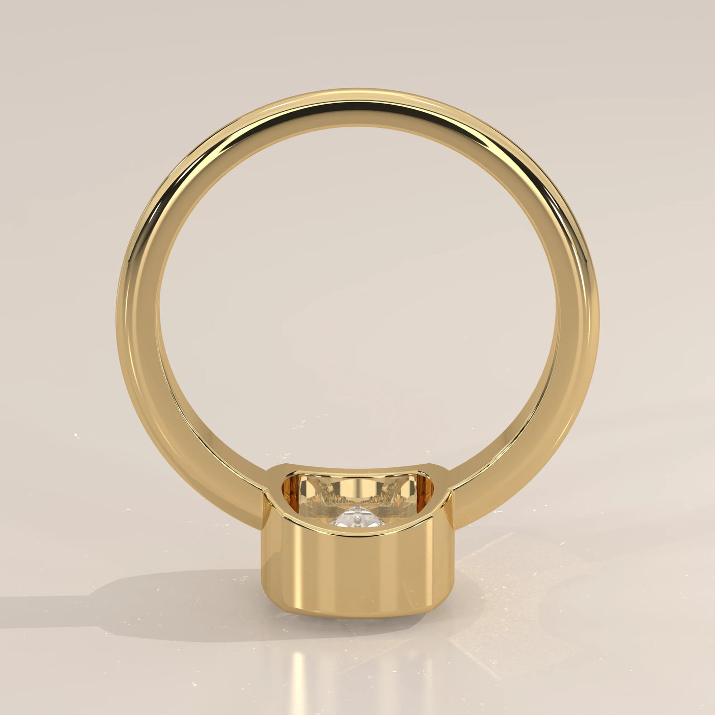 A 14k yellow gold ring with a bezel-set diamond on a plain band.