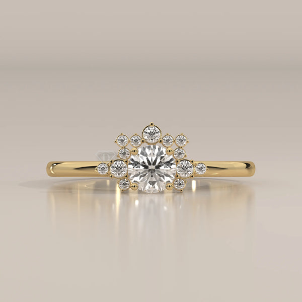 A delicate 14k yellow gold ring with a central round diamond surrounded by smaller diamonds.