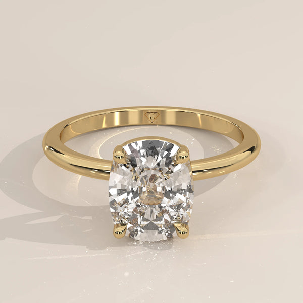A classic 14k yellow gold ring with a large cushion-cut diamond.