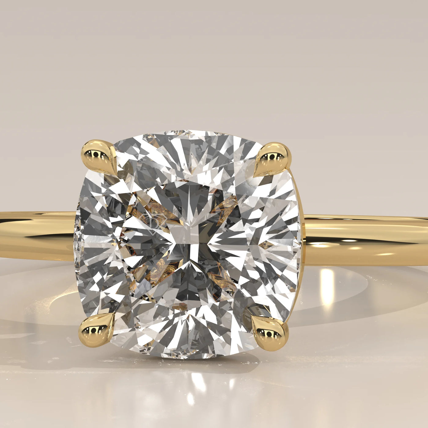 A cushion-cut diamond engagement ring in 14k yellow gold with pavé band.