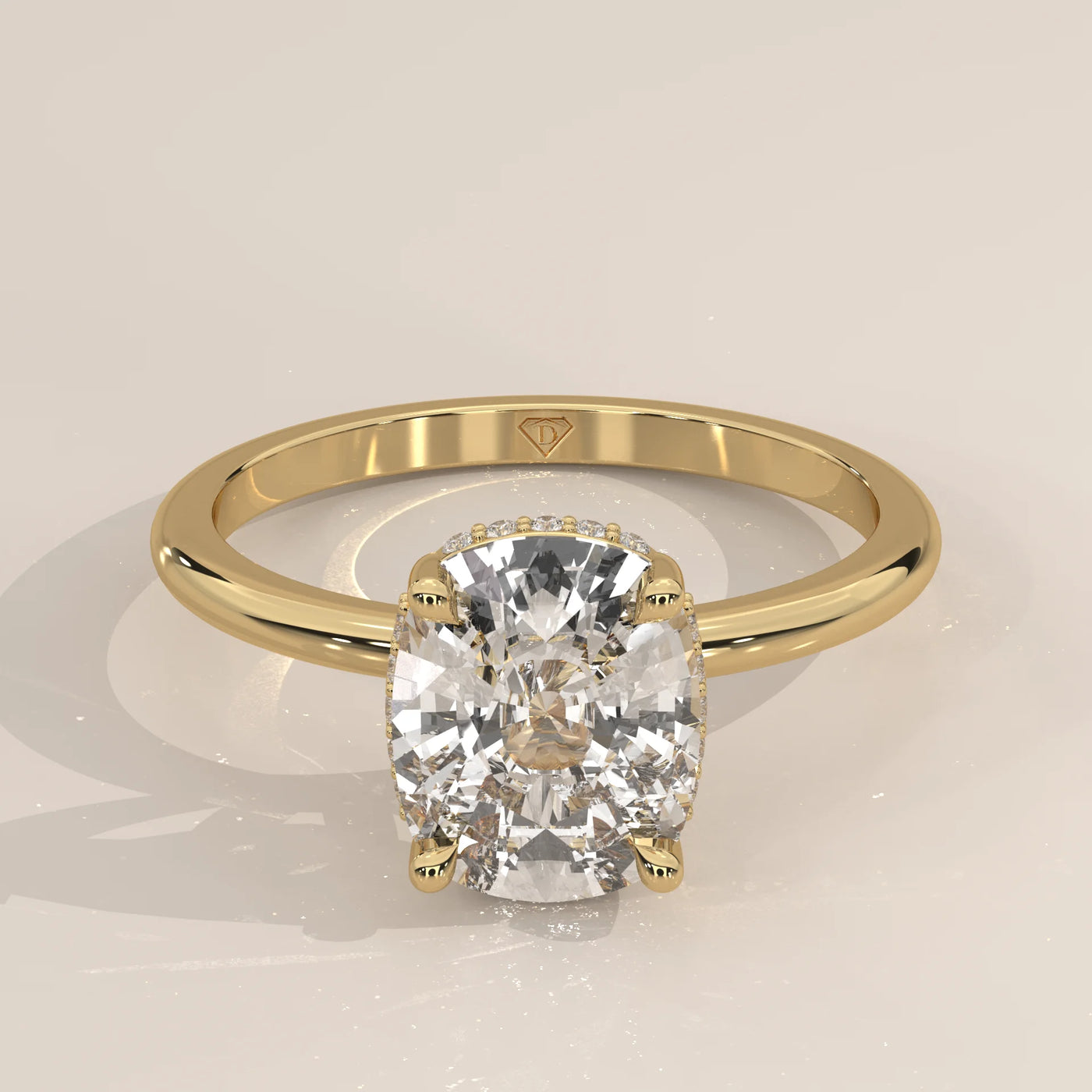 A cushion-cut diamond engagement ring in 14k yellow gold with pavé band.