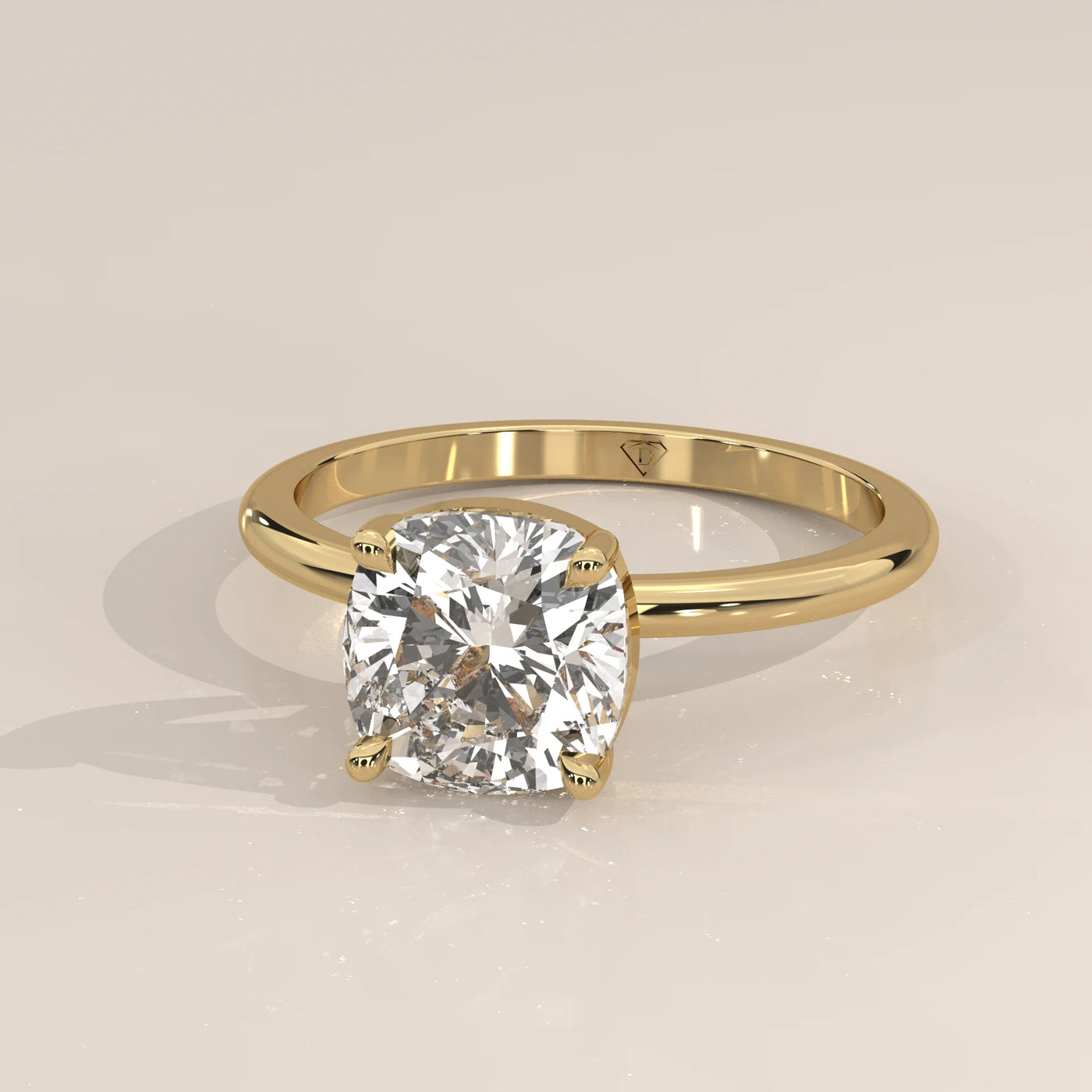 A yellow gold ring featuring a large cushion-cut diamond.