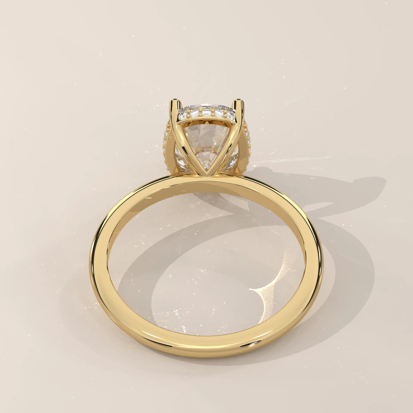 A 14k yellow gold ring with a cushion-cut moissanite center stone.