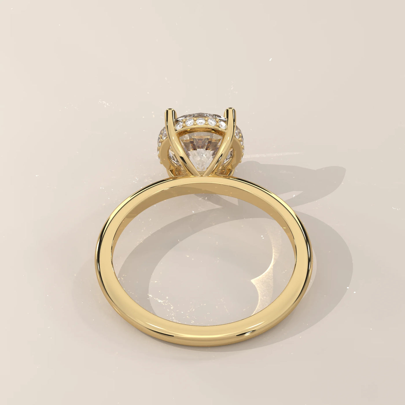 A classic yellow gold ring with a large cushion-cut diamond and halo.