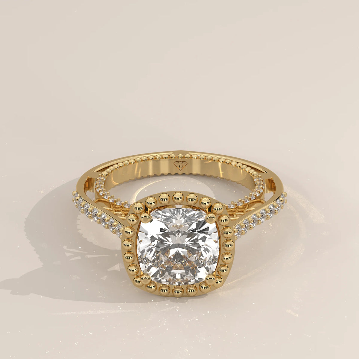 Yellow gold ring with a cushion-cut diamond and pave details.
