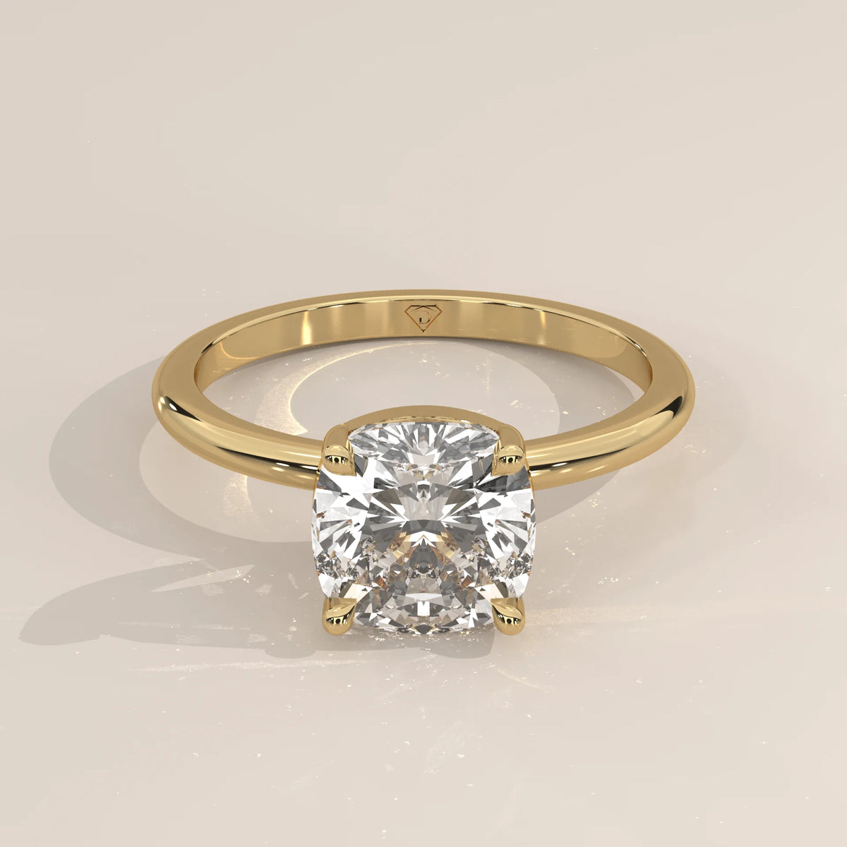 Yellow gold engagement ring with a cushion-cut diamond.
